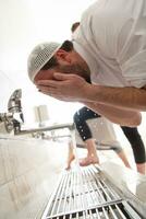 a group of Muslims take ablution for prayer. Islamic religious rite photo