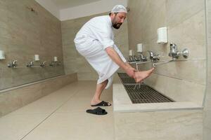 A Muslim takes ablution for prayer. Islamic religious rite photo