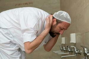 A Muslim takes ablution for prayer. Islamic religious rite photo