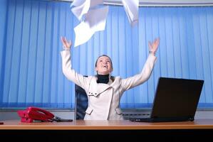 .happy businesswoman throwing papers in air photo