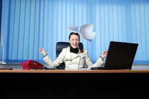 .happy businesswoman throwing papers in air photo