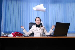 .happy businesswoman throwing papers in air photo