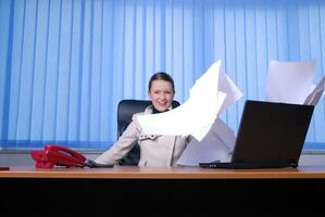 .happy businesswoman throwing papers in air photo