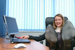 .business woman relaxing with her feet on the desk photo