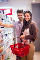 couple shopping in a supermarket photo