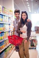 couple shopping in a supermarket photo