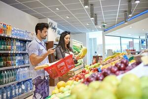 couple shopping in a supermarket photo