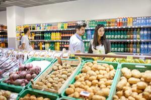 couple shopping in a supermarket photo