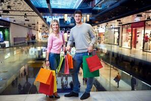 young couple with shipping bags photo