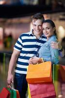 young couple with shipping bags photo