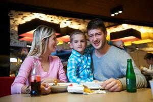 family having lunch in shopping mall photo