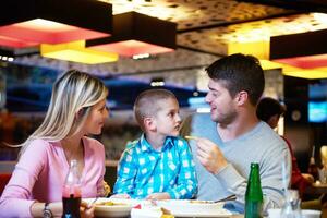 family having lunch in shopping mall photo