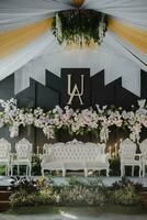 a wedding stage with white couches and flowers photo