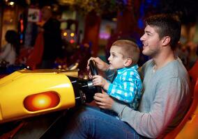 father and son playing game in playground photo