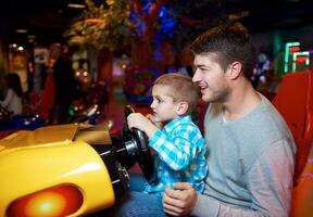 father and son playing game in playground photo