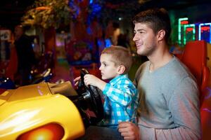 father and son playing game in playground photo