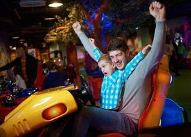 father and son playing game in playground photo