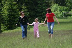 happy girls running in nature photo