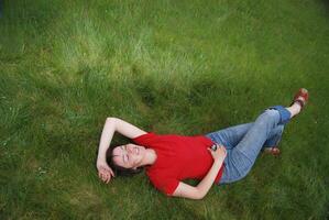 woman laying in grass photo