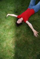 woman laying in grass photo