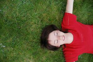 woman laying in grass photo