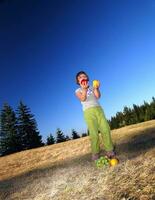 happy girl throwing apple outside photo