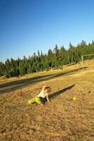 happy girl throwing apple outside photo