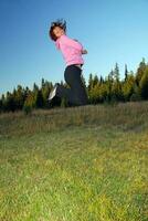 pretty girl jumping in a air photo