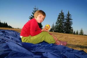 the girl eating apple in nature photo