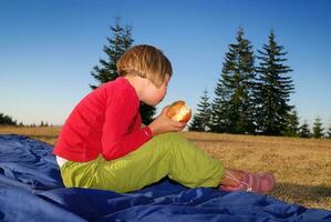 the girl eating apple in nature photo