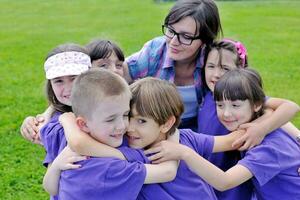 happy kids group with teacher in nature photo