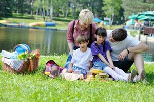 Happy family playing together in a picnic outdoors photo