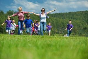 happy kids group with teacher in nature photo