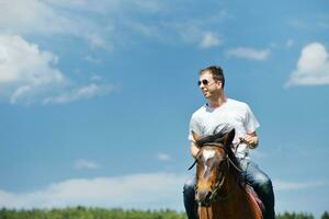 man ride horse photo