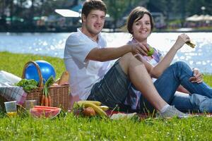 happy young couple having a picnic outdoor photo