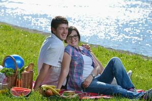 happy young couple having a picnic outdoor photo