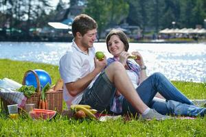 happy young couple having a picnic outdoor photo