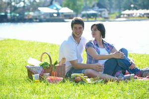 happy young couple having a picnic outdoor photo