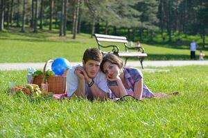 happy young couple having a picnic outdoor photo