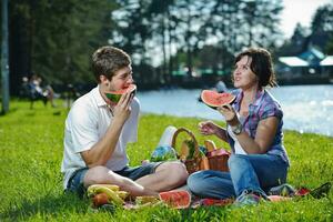 happy young couple having a picnic outdoor photo