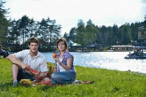 happy young couple having a picnic outdoor photo