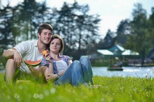 happy young couple having a picnic outdoor photo