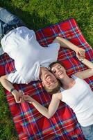 happy young couple having a picnic outdoor photo