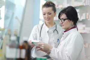 team of pharmacist chemist woman  in pharmacy drugstore photo