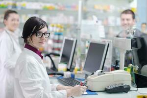 pharmacist suggesting medical drug to buyer in pharmacy drugstore photo