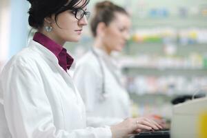 team of pharmacist chemist woman  in pharmacy drugstore photo