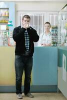 pharmacist suggesting medical drug to buyer in pharmacy drugstore photo