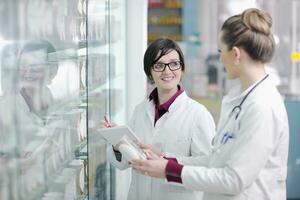 team of pharmacist chemist woman  in pharmacy drugstore photo