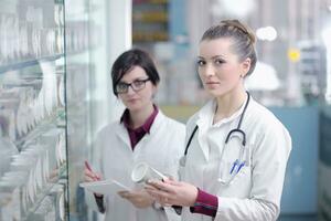 team of pharmacist chemist woman  in pharmacy drugstore photo