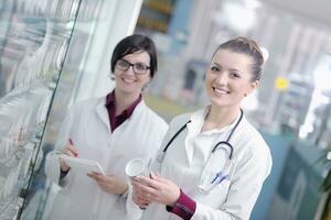 team of pharmacist chemist woman  in pharmacy drugstore photo